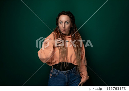 Woman With Dreadlocks Standing in Front of Green Background 116763178