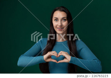 Woman Making Heart Shape With Hands Woman Making Heart Shape With Hands 116763223