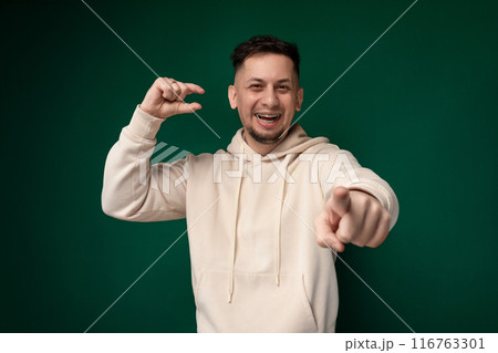 Man in White Hoodie Pointing at Camera 116763301