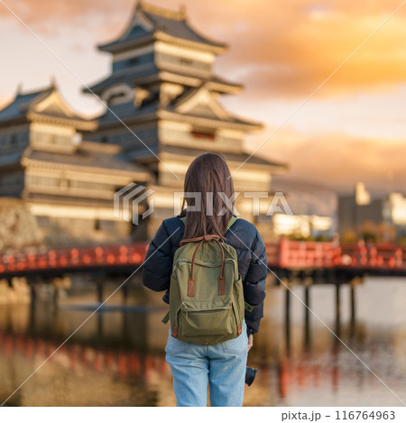 Woman tourist Visiting in Matsumoto, happy Traveler sightseeing Matsumoto Castle or Crow castle. Landmark and popular for tourists attraction in Matsumoto, Nagano, Japan. Travel and Vacation concept Woman tourist Visiting in Matsumoto, happy Traveler sightseeing Matsumoto Castle or Crow castle. Landmark and popular for tourists attraction in Matsumoto, Nagano, Japan. Travel and Vacation concept 116764963