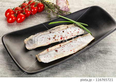 Marinated herring fillet with green onion 116765721