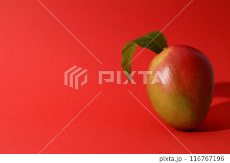 Ripe delicious mango on a red background 116767196
