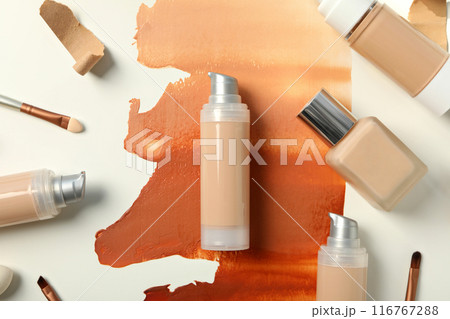 Bottles with foundation and brushes on white background, top view 116767288
