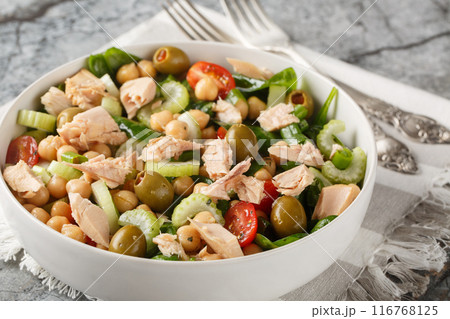 Chickpea tuna salad that's filled with bright flavor and fresh ingredients like tomatoes, celery, spinach and homemade dressing close-up in a bowl. Horizontal Chickpea tuna salad that's filled with bright flavor and fresh ingredients like tomatoes, celery, spinach and homemade dressing close-up in a bowl. Horizontal 116768125