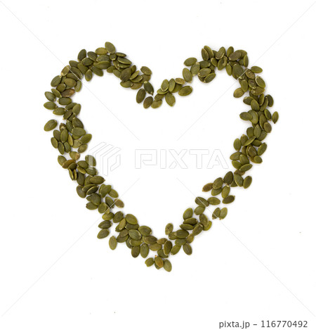 heart of green pumpkin seeds isolated on white background heart of green pumpkin seeds isolated on white background 116770492