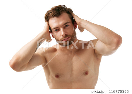 Portrait of handsome young man standing shirtless, showing perfect well-kept healthy hair, emphasizing importance of hair care, isolated on white background 116770596