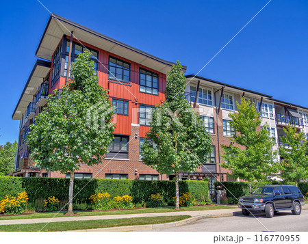 New residential apartment building with a truck parked on the roadside. New residential apartment building with a truck parked on the roadside. 116770955