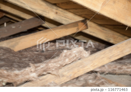 Construction worker thermally insulating house mineral wool attic with glass wool Construction worker thermally insulating house mineral wool attic with glass wool 116771463