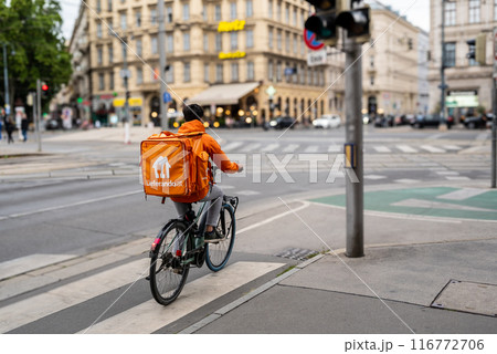 Vienna, Austria, August 21, 2022. A rider from Lieferando, home delivery company for food and drink. It is easy to notice them Vienna, Austria, August 21, 2022. A rider from Lieferando, home delivery company for food and drink. It is easy to notice them 116772706