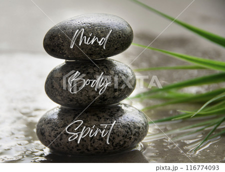 Mind, body and spirit text on zen stones. Spiritual and health concept Mind, body and spirit text on zen stones. Spiritual and health concept 116774093