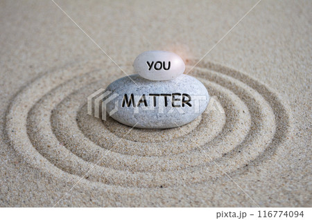 You matter text engraved on Zen stone on sand with light shining. Motivational and inspirational concept 116774094