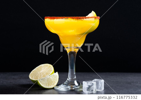 Fresh mango cocktail. Mexican mango cocktail on black slate background Fresh mango cocktail. Mexican mango cocktail on black slate background 116775332