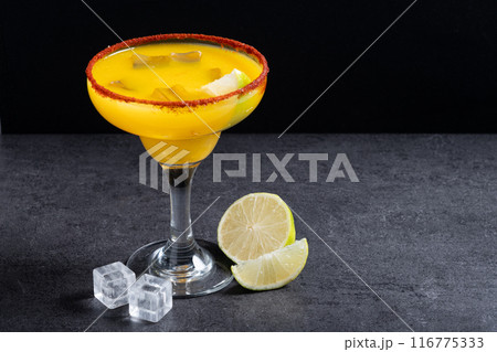 Fresh mango cocktail. Mexican mango cocktail on black slate background Fresh mango cocktail. Mexican mango cocktail on black slate background 116775333