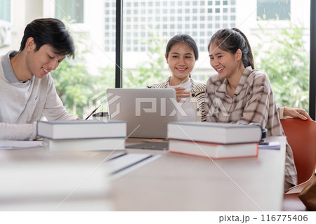 Group of Happy Students Studying Together with Laptops and Books in a Bright Modern Classroom Group of Happy Students Studying Together with Laptops and Books in a Bright Modern Classroom 116775406