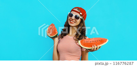 Summer portrait of happy young woman eating fresh slice of watermelon on blue background 116776287