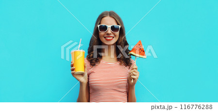 Summer portrait of happy woman with cup of juice and sweet lollipop watermelon on blue background Summer portrait of happy woman with cup of juice and sweet lollipop watermelon on blue background 116776288