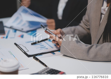 Close up of Business team analyzing income charts and graphs with modern laptop computer. Business analysis and strategy concept. 116776810