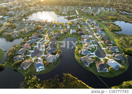Waterfront single family homes in Florida residential area at sunset. Real estate development in American suburbs 116777783