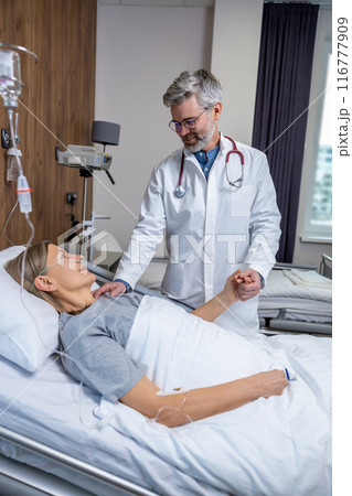 Doctor talking to a patient in clinic and looking involved and concerned 116777909