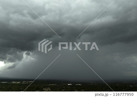 Stormy cumulonimbus clouds forming before thunderstorm on dark sky. Moving and changing cloudscape weather 116777950