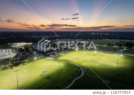 Sportsmen training in soccer game on illuminated football stadium in public sports park in North Port, Florida Sportsmen training in soccer game on illuminated football stadium in public sports park in North Port, Florida 116777955
