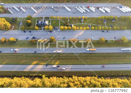 Rest area for semi trucks near busy interstate freeway. Truck stop place during hauling cargo Rest area for semi trucks near busy interstate freeway. Truck stop place during hauling cargo 116777992