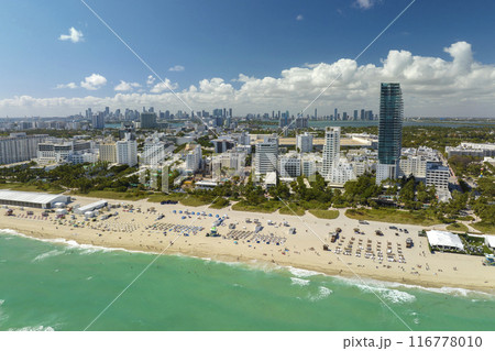 Popular vacation spot in the United States. Ocean warm waters and sandy beachfront at Miami Beach in Florida, USA. American travel destination 116778010