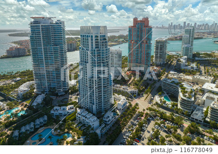 Miami Beach city in southern Florida, USA. High luxury hotels and condominium buildings. High angle view of tourist infrastructure in United States Miami Beach city in southern Florida, USA. High luxury hotels and condominium buildings. High angle view of tourist infrastructure in United States 116778049