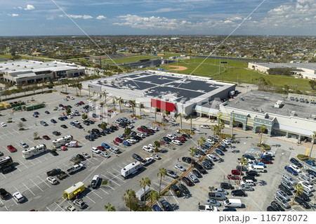 Large parking lot with many parked cars. Big carpark at supercenter shopping mall with lines and markings for vehicle places and directions Large parking lot with many parked cars. Big carpark at supercenter shopping mall with lines and markings for vehicle places and directions 116778072