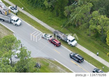 Traffic accident on American street in Florida. First responders helping victims of car crash on road in USA. Aerial view of emergency services personnel and vehicles responding to accident site Traffic accident on American street in Florida. First responders helping victims of car crash on road in USA. Aerial view of emergency services personnel and vehicles responding to accident site 116778266