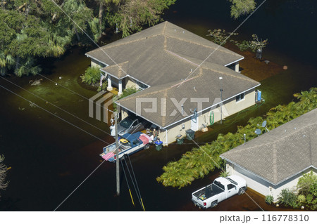 Surrounded by hurricane rainfall flood waters homes in Florida residential area. Aftermath of natural disaster Surrounded by hurricane rainfall flood waters homes in Florida residential area. Aftermath of natural disaster 116778310