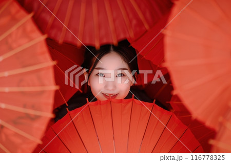 Woman Posing With Red Umbrellas 116778325