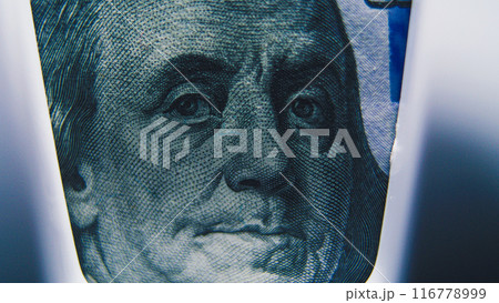 Hundred dollar banknote lying in paper money counting machine Hundred dollar banknote lying in paper money counting machine 116778999