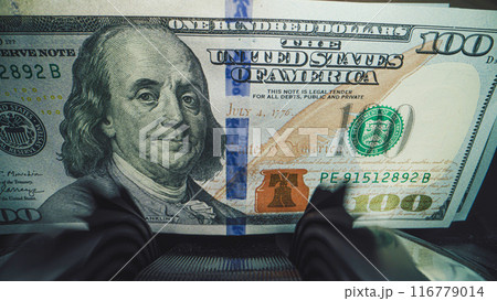 Close up of bill counter machine counting hundred dollar banknotes 116779014