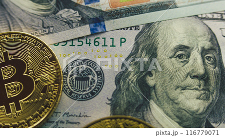 Golden bitcoin coins and hundred dollar bills Golden bitcoin coins and hundred dollar bills 116779071