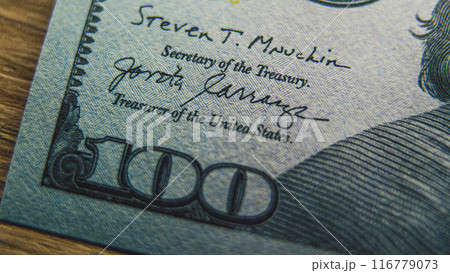 Process of examining authenticity of of hundred dollar bill 116779073