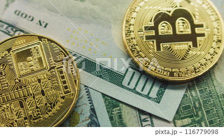 Golden bitcoin coins and hundred dollar bills 116779098