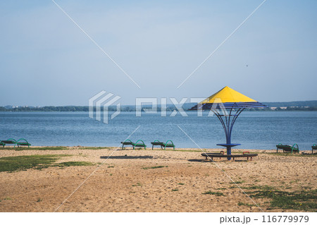 Gazebos with a yellow dome on the beach by the lake Gazebos with a yellow dome on the beach by the lake 116779979