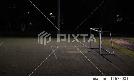 Night, school football stadium. The gates of the school and football stadium are illuminated by a street lamp Night, school football stadium. The gates of the school and football stadium are illuminated by a street lamp 116780039