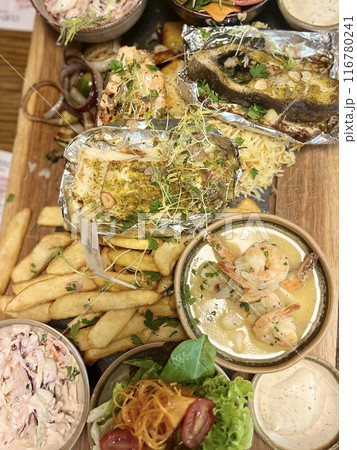 Seafood platter in a restaurant on a wooden board 116780241