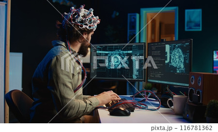 Computer scientist putting EEG headset on, starting mind upload process, trying to gain bionic powers. Man using high tech neuroscientific gear to transfer consciousness into cyberspace, camera B 116781362