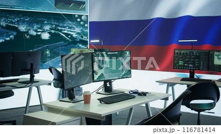 Empty russian army command center with a big screen showing the national flag, working on spreading fake news and propaganda to inflict fear and misinformation. Terrorist ideology. Camera B. Empty russian army command center with a big screen showing the national flag, working on spreading fake news and propaganda to inflict fear and misinformation. Terrorist ideology. Camera B. 116781414