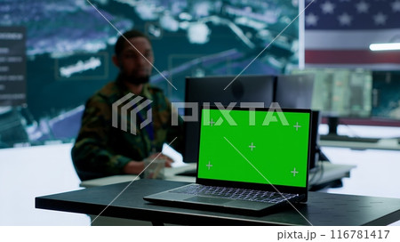 US army working in a top secret control center with isolated mockup screen, ensuring national safety while studying surveillance footage from radar cctv. Command service. Camera A. US army working in a top secret control center with isolated mockup screen, ensuring national safety while studying surveillance footage from radar cctv. Command service. Camera A. 116781417