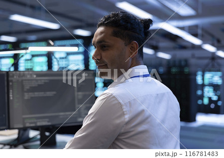 Computer scientist in data center using diagnostic tools and system monitoring software to identify root cause of errors. IT specialist in server farm establishment repairing equipment Computer scientist in data center using diagnostic tools and system monitoring software to identify root cause of errors. IT specialist in server farm establishment repairing equipment 116781483