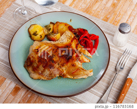 Spanish dish - Secreto de cerdo, roasted pork served with potatoes and stewed pepper at plate Spanish dish - Secreto de cerdo, roasted pork served with potatoes and stewed pepper at plate 116783168