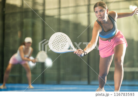 Emotional woman training padel at group workout 116783593