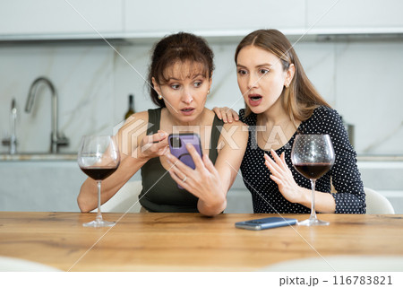 During gatherings, women look at mobile phone screen During gatherings, women look at mobile phone screen 116783821