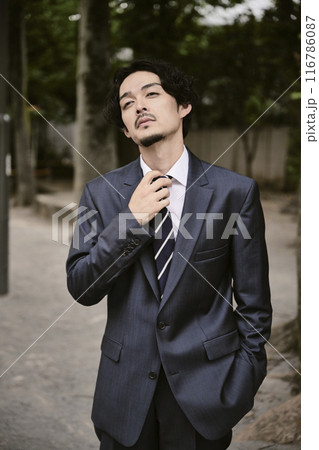 屋外にいる表情豊かなスーツ姿の男性 116786087