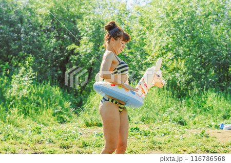 a girl is swimming in the river 116786568