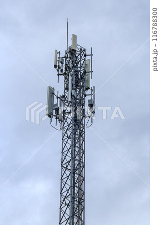 Telecommunication tower with blue sky and green leaves. Technology background. 116788300